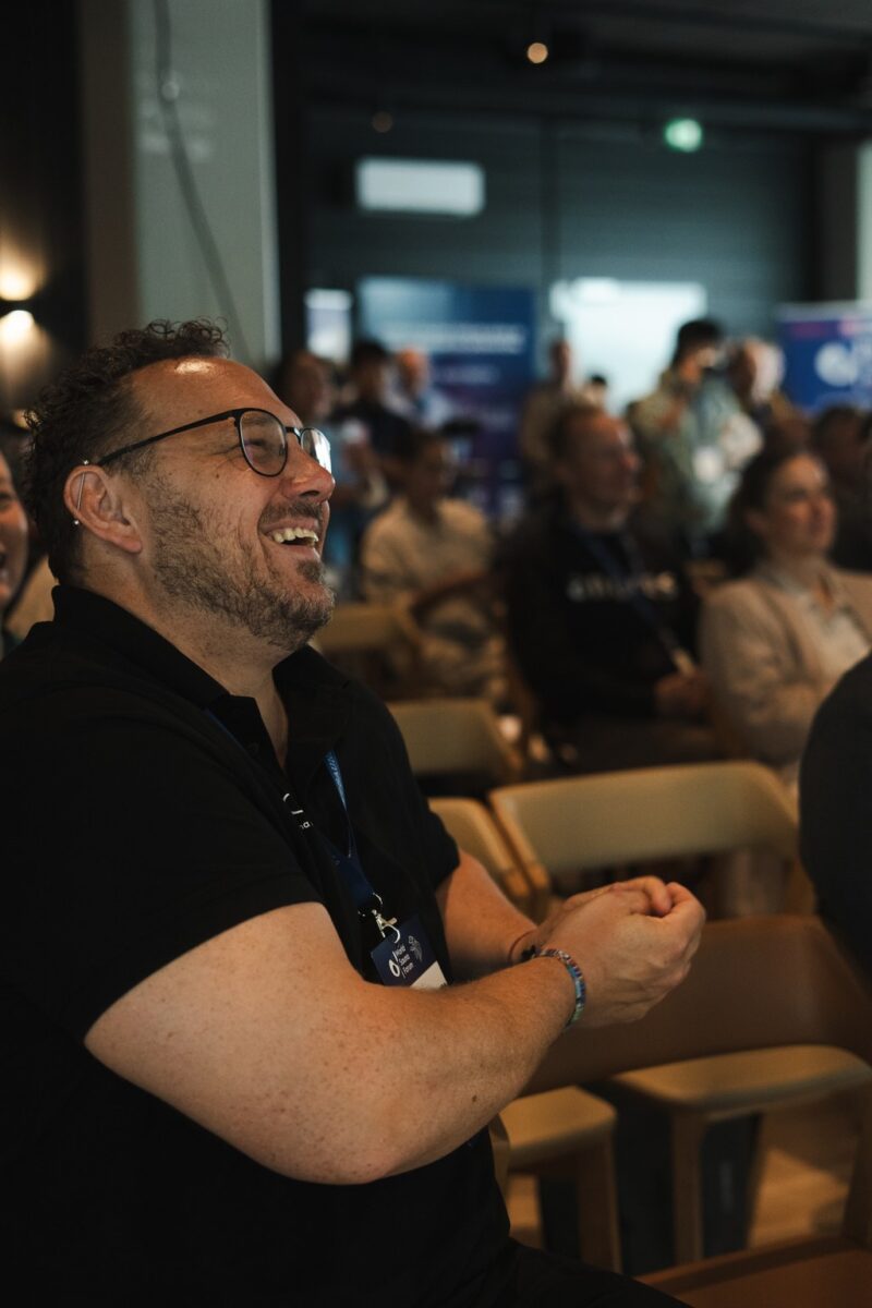Person laughing in the audience of the World Sauna Forum