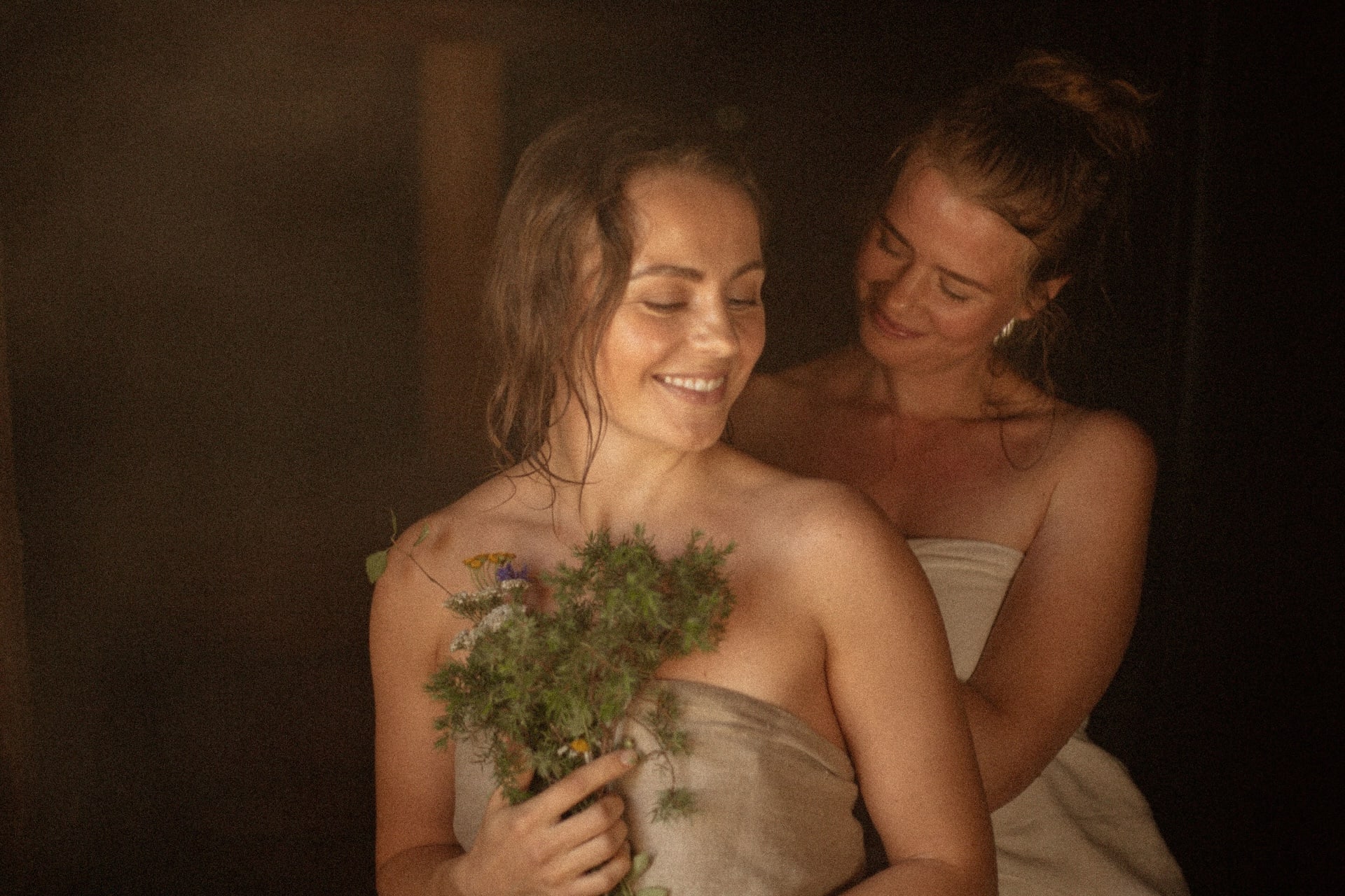 Two women enjoying modern Finnish sauna rituals