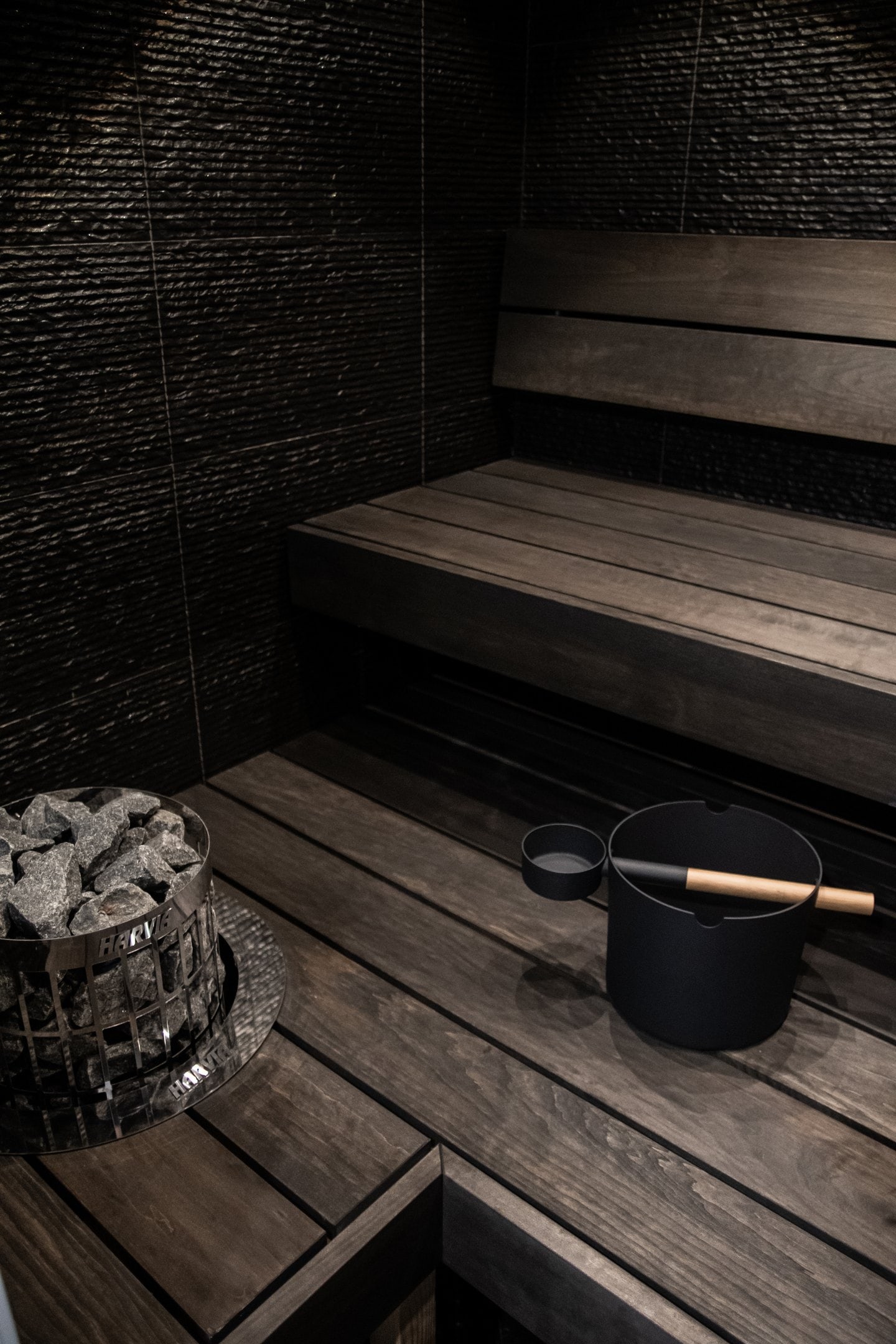 Sauna bucket and heater inside a sauna