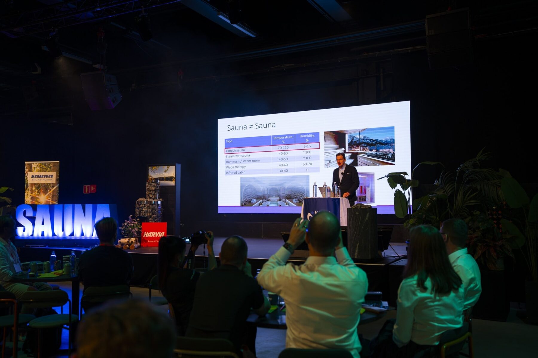 Jari Laukkanen on a stage doing keynote presentation at the World Sauna Forum 2026