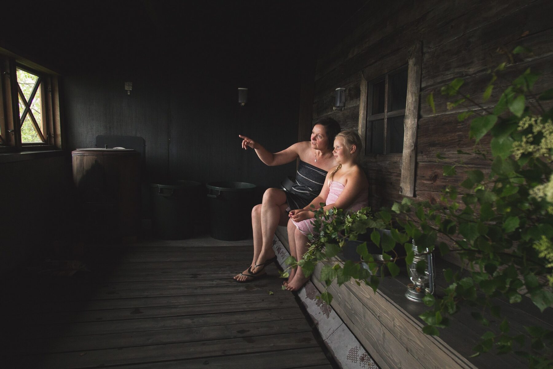 Woman and child cooling down at the terrace after a Finnish sauna