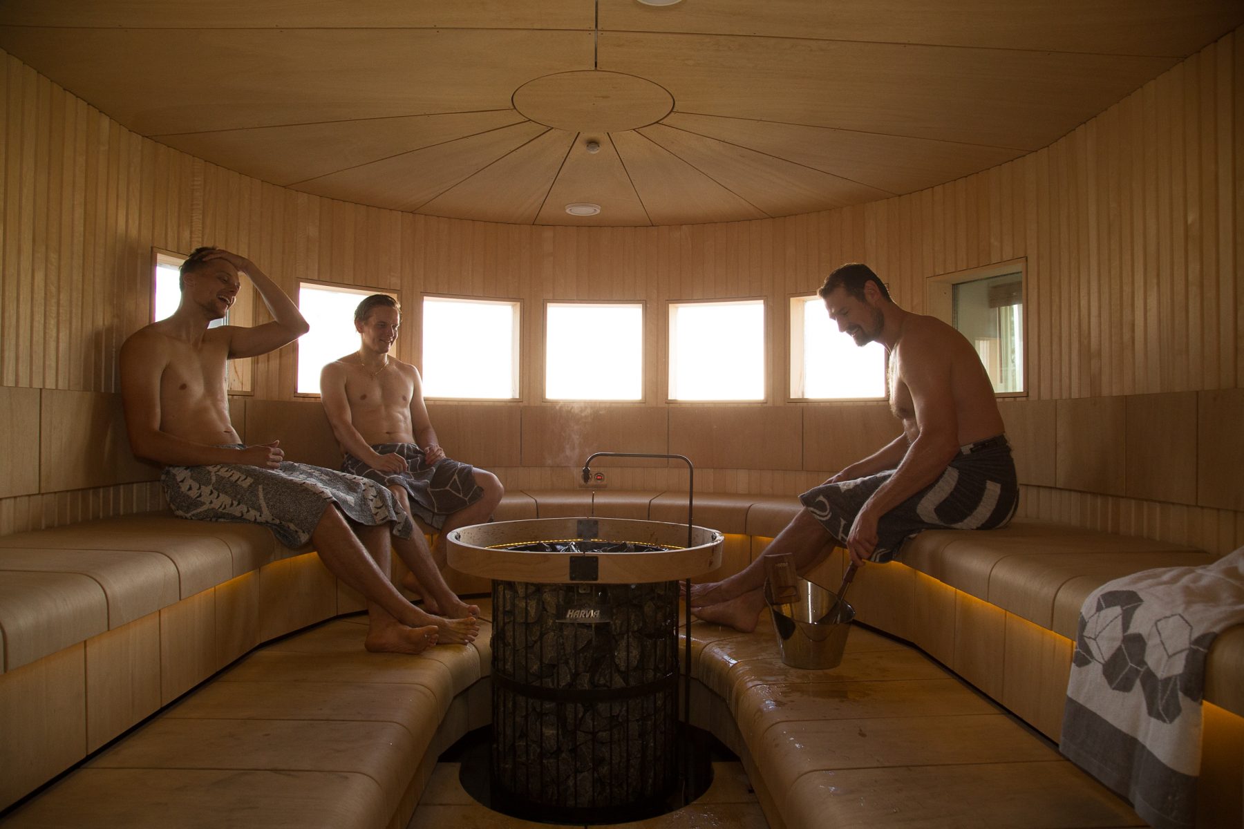 men sitting in harvia sauna